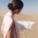 Woman wearing pink textured maxi dress in desert setting — Lichi | Endless UAE