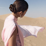 Woman wearing pink textured maxi dress in desert setting — Lichi | Endless UAE