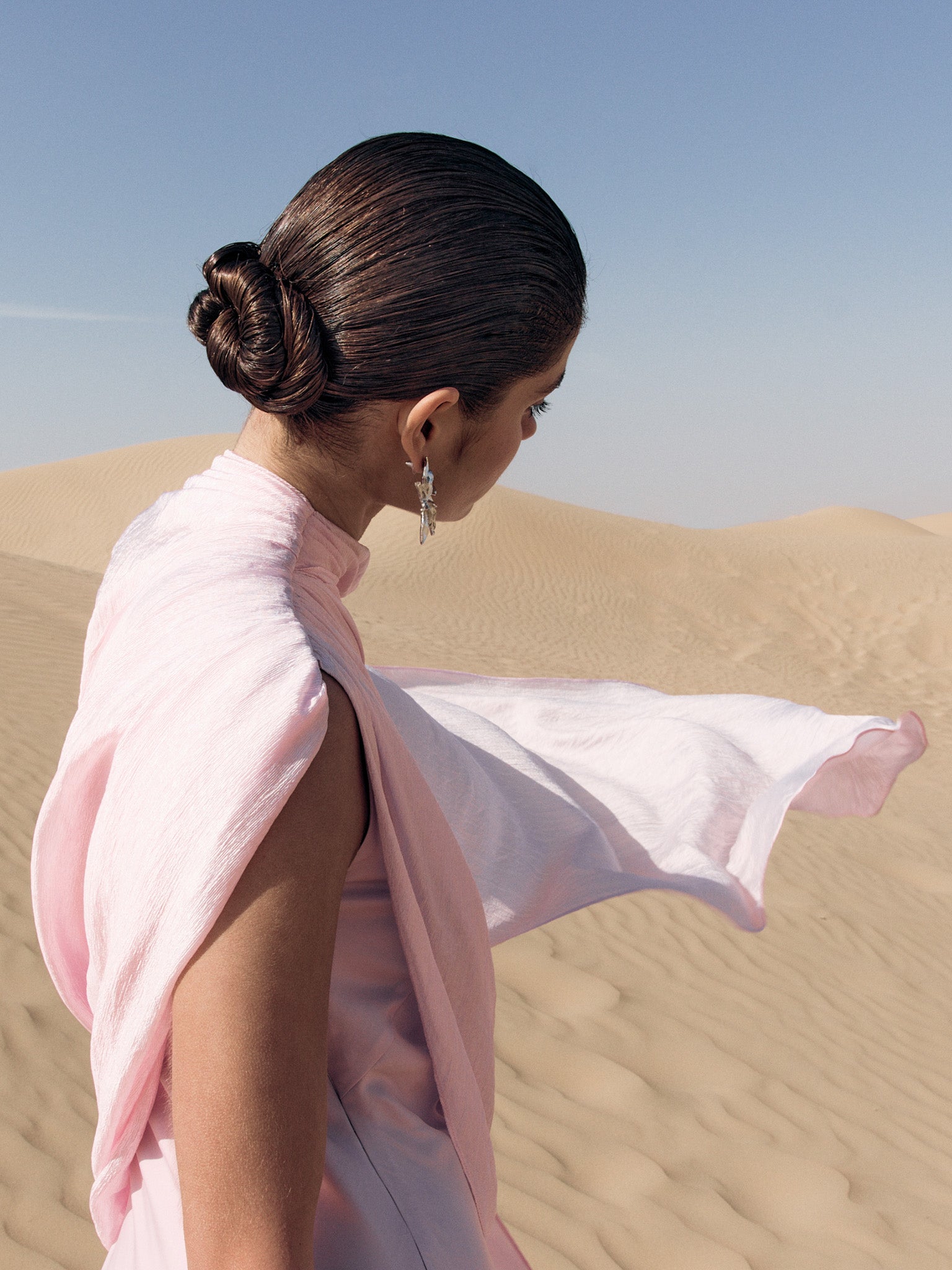 Woman wearing pink textured maxi dress in desert setting — Lichi | Endless UAE
