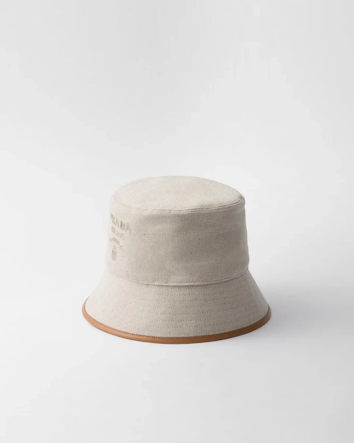 Cream linen blend bucket hat with tan leather trim and Prada logo — Prada | Endless UAE