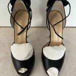 Black leather peep-toe platform pumps with bow detail and lace-up ankle straps — Christian Louboutin | Endless UAE
