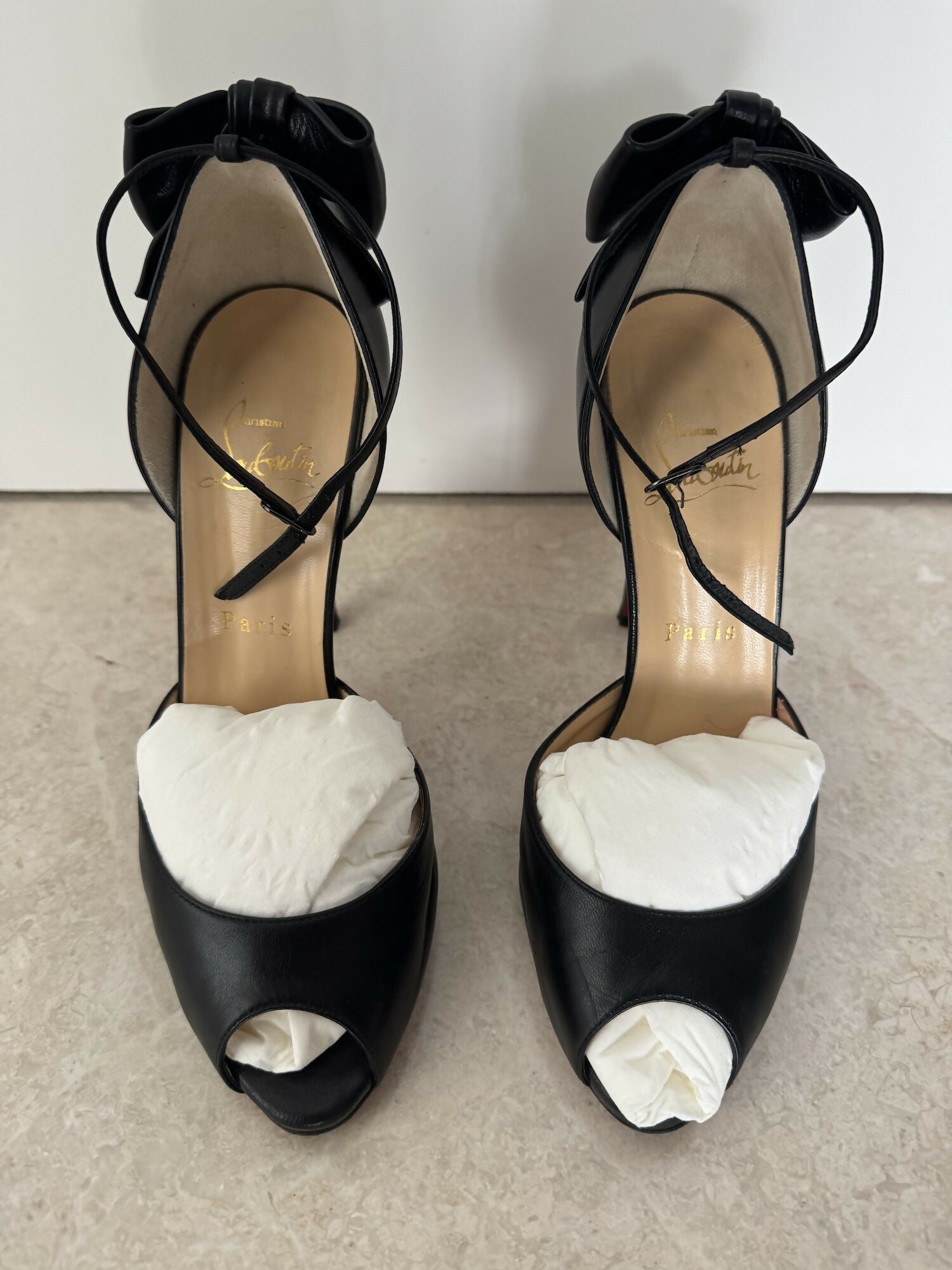 Black leather peep-toe platform pumps with bow detail and lace-up ankle straps — Christian Louboutin | Endless UAE