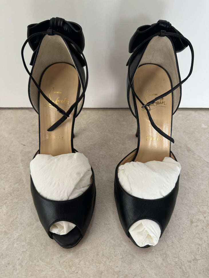 Black leather peep-toe platform pumps with bow detail and lace-up ankle straps — Christian Louboutin | Endless UAE
