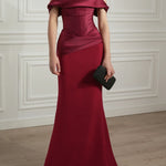 Elegant ruby red off-shoulder satin gown with draped bodice and mermaid silhouette — Rhea Costa | Endless UAE