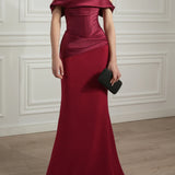 Elegant ruby red off-shoulder satin gown with draped bodice and mermaid silhouette — Rhea Costa | Endless UAE
