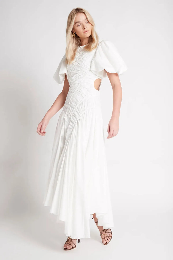 Woman wearing white Siren Drawstring Midi Dress with puffed sleeves and green strappy heels — Aje | Endless UAE