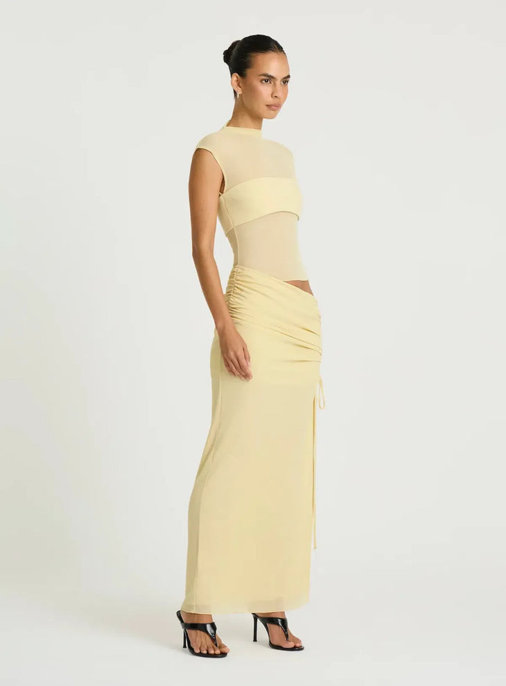 Pale yellow sleeveless maxi dress with cutout waist detail and ruched skirt — BENNI. | Endless UAE.