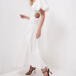Woman wearing white Siren Drawstring Midi Dress with puffed sleeves and green strappy heels — Aje | Endless UAE