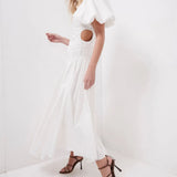Woman wearing white Siren Drawstring Midi Dress with puffed sleeves and green strappy heels — Aje | Endless UAE