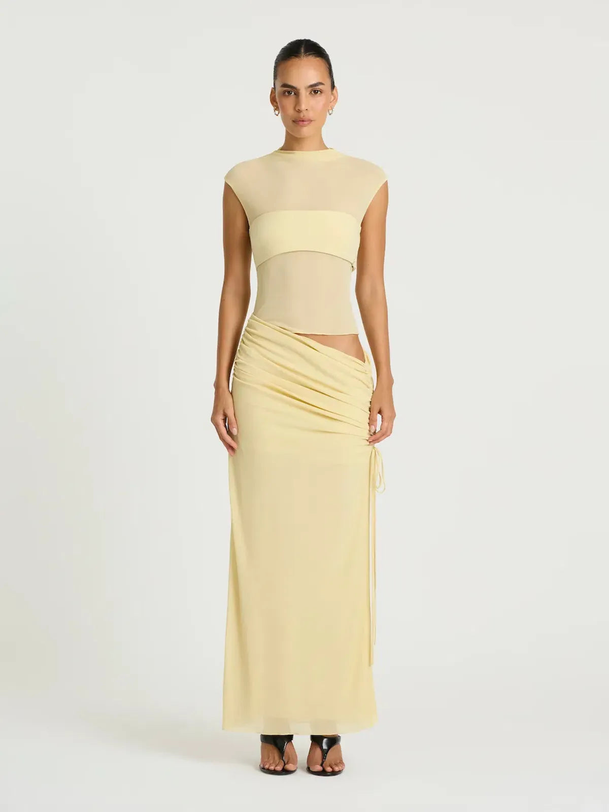 Pale yellow sleeveless maxi dress with cutout waist detail and ruched skirt — BENNI. | Endless UAE.