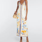 Woman wearing a floral printed white linen midi dress with blue and yellow trim — Zimmerman | Endless UAE