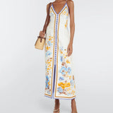 Woman wearing a floral printed white linen midi dress with blue and yellow trim — Zimmerman | Endless UAE