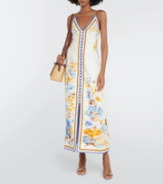 Woman wearing a floral printed white linen midi dress with blue and yellow trim — Zimmerman | Endless UAE