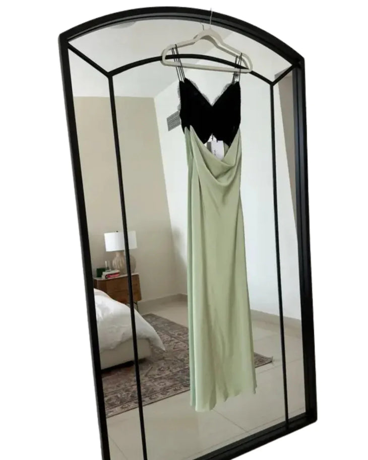 Woman wearing black and sage green color-block satin maxi dress with cutout detail — Misha | Endless UAE