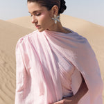 Woman wearing pink textured maxi dress in desert setting — Lichi | Endless UAE