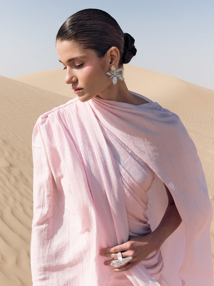 Woman wearing pink textured maxi dress in desert setting — Lichi | Endless UAE