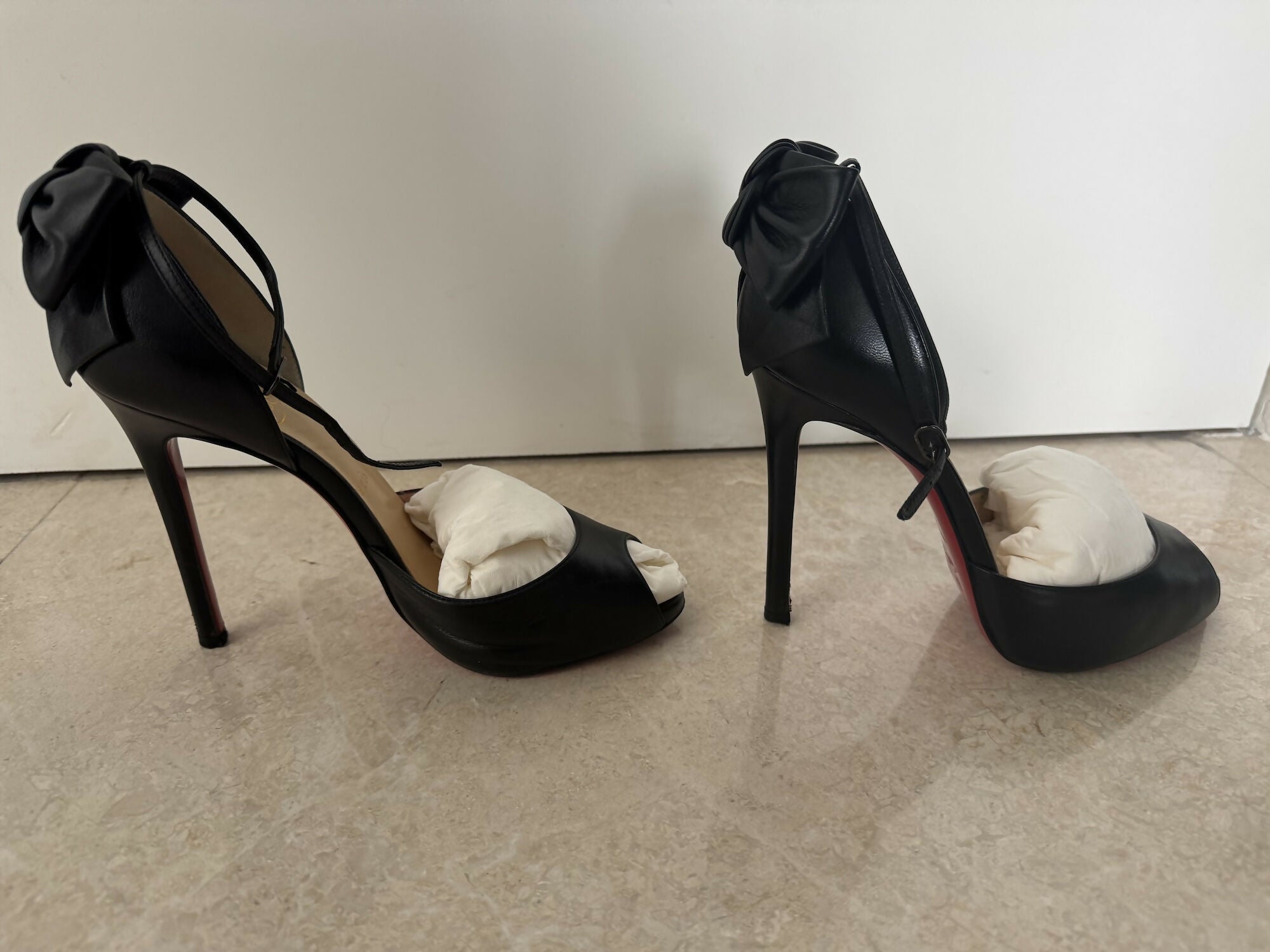 Black leather peep-toe platform pumps with bow detail and lace-up ankle straps — Christian Louboutin | Endless UAE