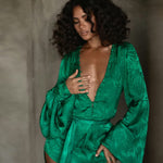 Woman wearing emerald green Harlequin Dress with palm print and flowing sleeves — Rat & Boa | Endless UAE