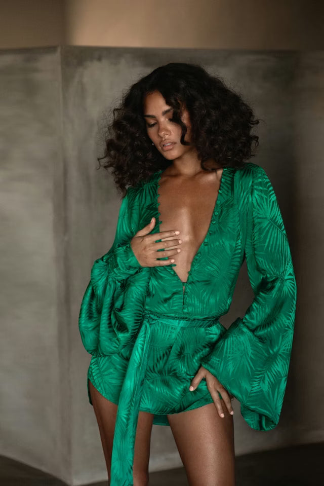 Woman wearing emerald green Harlequin Dress with palm print and flowing sleeves — Rat & Boa | Endless UAE