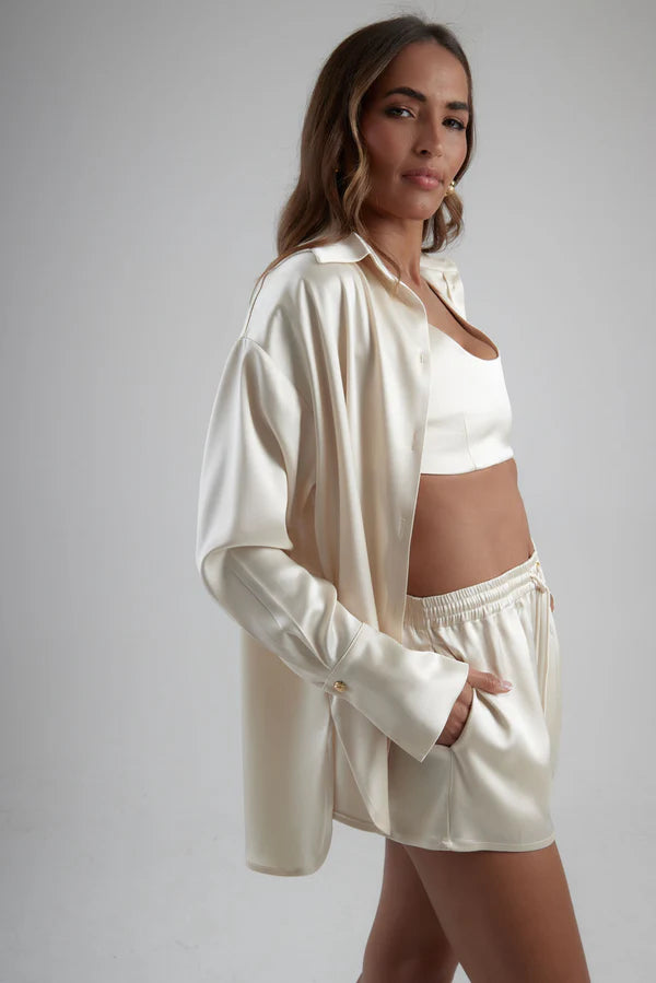 Ivory satin sculpted bralette styled with matching oversized shirt and shorts in luxe coordinated set — By Keara | Endless UAE