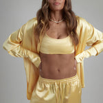 Cream Sculpted Bralette worn with matching satin jacket and pants — By Keara | Endless UAE