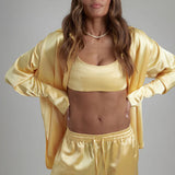 Cream Sculpted Bralette worn with matching satin jacket and pants — By Keara | Endless UAE