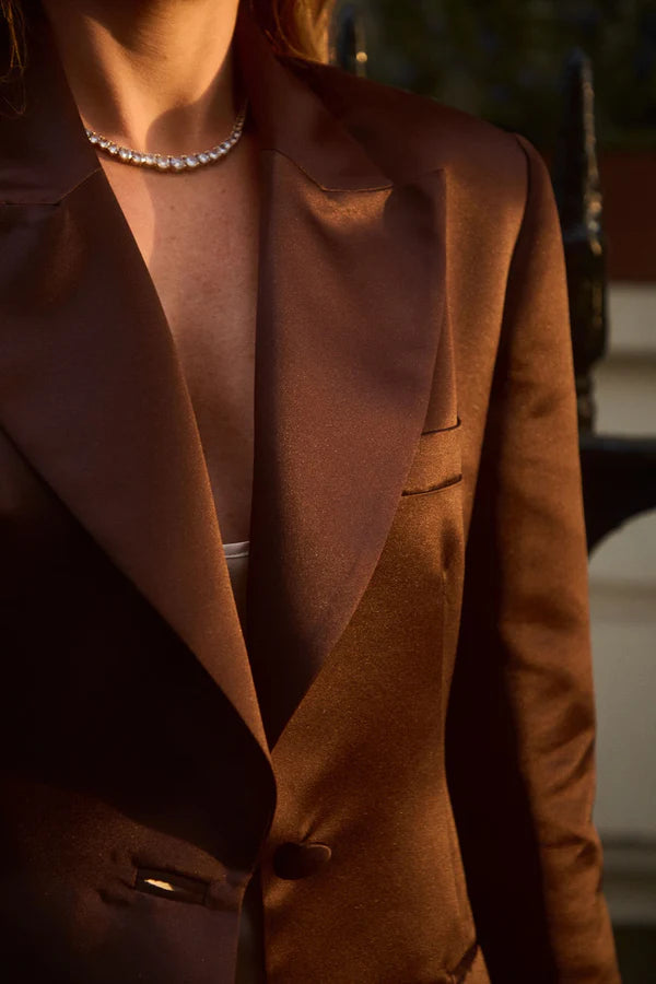 Elegant brown blazer with peak lapels and button closure worn over pearl necklace — By Keara | Endless UAE
