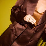 Elegant brown double-breasted blazer with gold metallic top and statement rings — By Keara | Endless UAE