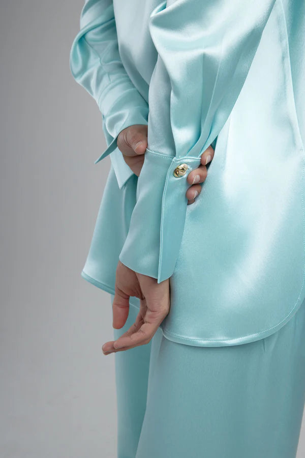 Light blue oversized shirt worn open over white crop top with matching pants — By Keara | Endless UAE