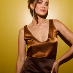 Elegant black satin mini skirt with sleek silhouette modeled against yellow background — By Keara | Endless UAE