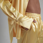 Woman wearing oversized cream silk shirt and matching pants, back view — By Keara | Endless UAE