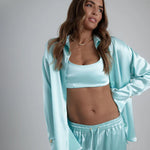 Light blue satin sculpted bralette styled with matching pajama set and robe — By Keara | Endless UAE