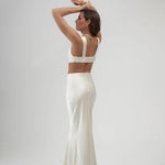 Elegant ivory satin maxi skirt with high waist and flowing silhouette, shown from back view — By Keara | Endless UAE