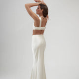 Elegant ivory satin maxi skirt with high waist and flowing silhouette, shown from back view — By Keara | Endless UAE