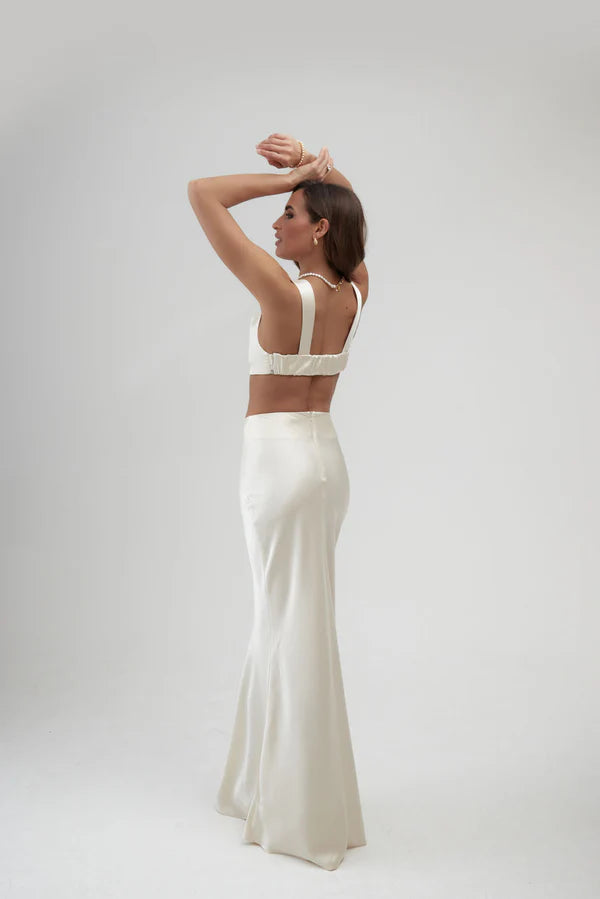 Elegant ivory satin maxi skirt with high waist and flowing silhouette, shown from back view — By Keara | Endless UAE