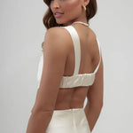 Elegant ivory satin maxi skirt with back zipper closure, paired with matching crop top featuring pearl strap detail — By Keara | Endless UAE