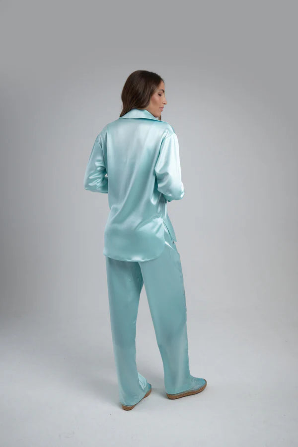 Light blue oversized shirt worn open over white crop top with matching pants — By Keara | Endless UAE
