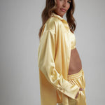 Woman wearing oversized cream silk shirt and matching pants, back view — By Keara | Endless UAE