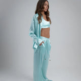 Light blue oversized shirt worn open over white crop top with matching pants — By Keara | Endless UAE