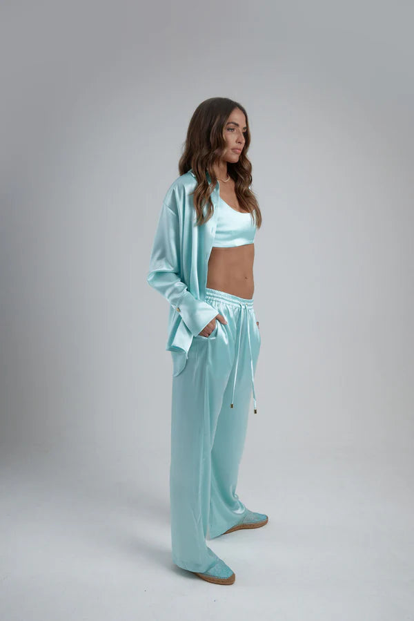 Light blue oversized shirt worn open over white crop top with matching pants — By Keara | Endless UAE