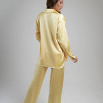 Woman wearing oversized cream silk shirt and matching pants, back view — By Keara | Endless UAE