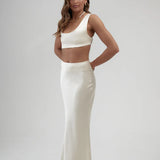 Elegant white satin maxi skirt with high waist and sleek silhouette, paired with matching crop top — By Keara | Endless UAE