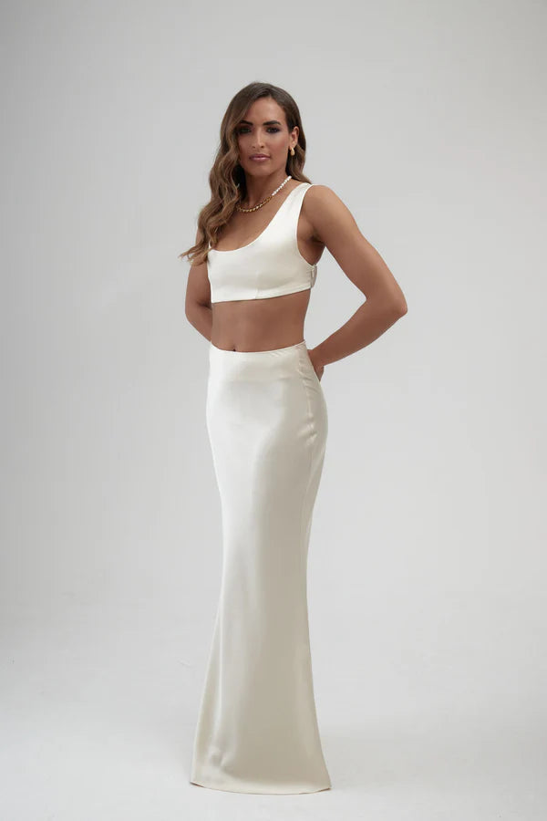 Elegant white satin maxi skirt with high waist and sleek silhouette, paired with matching crop top — By Keara | Endless UAE