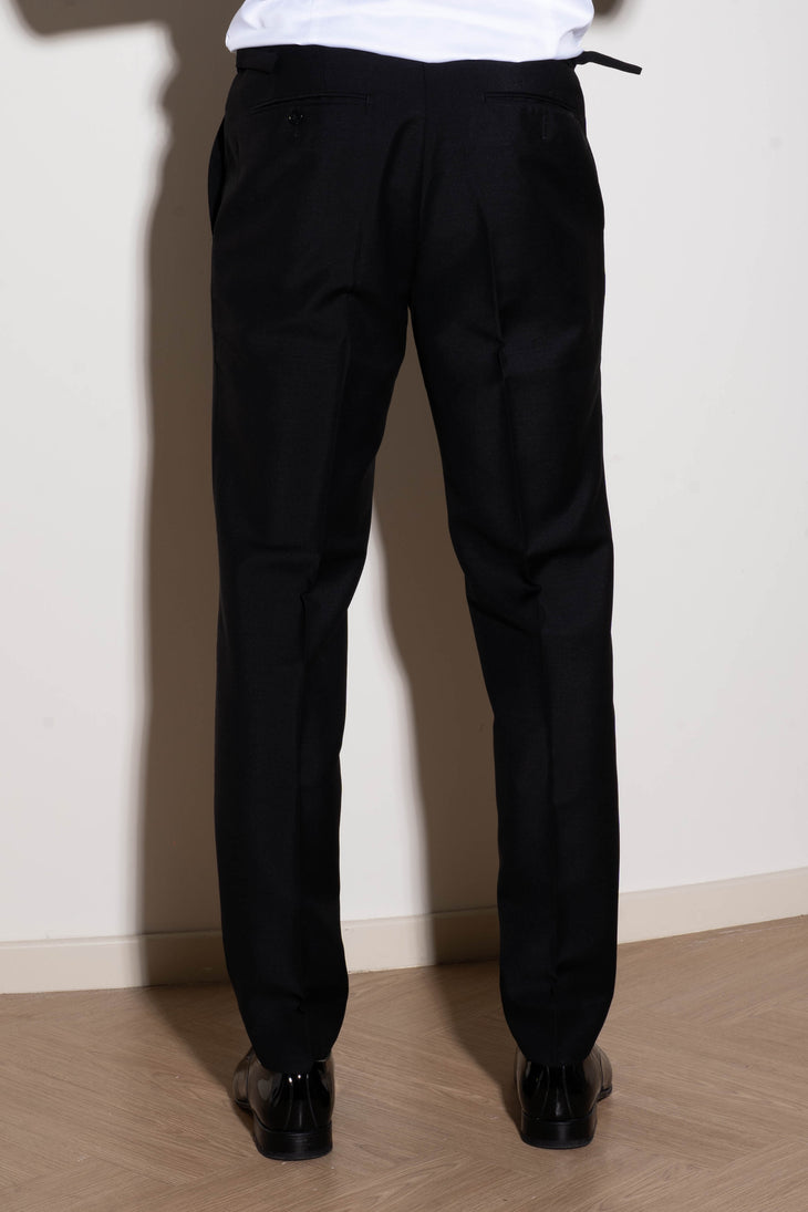 Man wearing black tuxedo trousers with white dress shirt and bow tie at formal event — Endless | Endless UAE