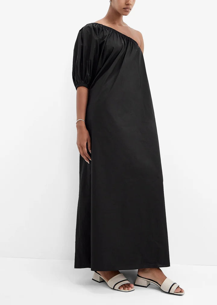 Model wearing black one-shoulder maxi dress with white and black Ella Mules sandals — The LLine | Endless UAE