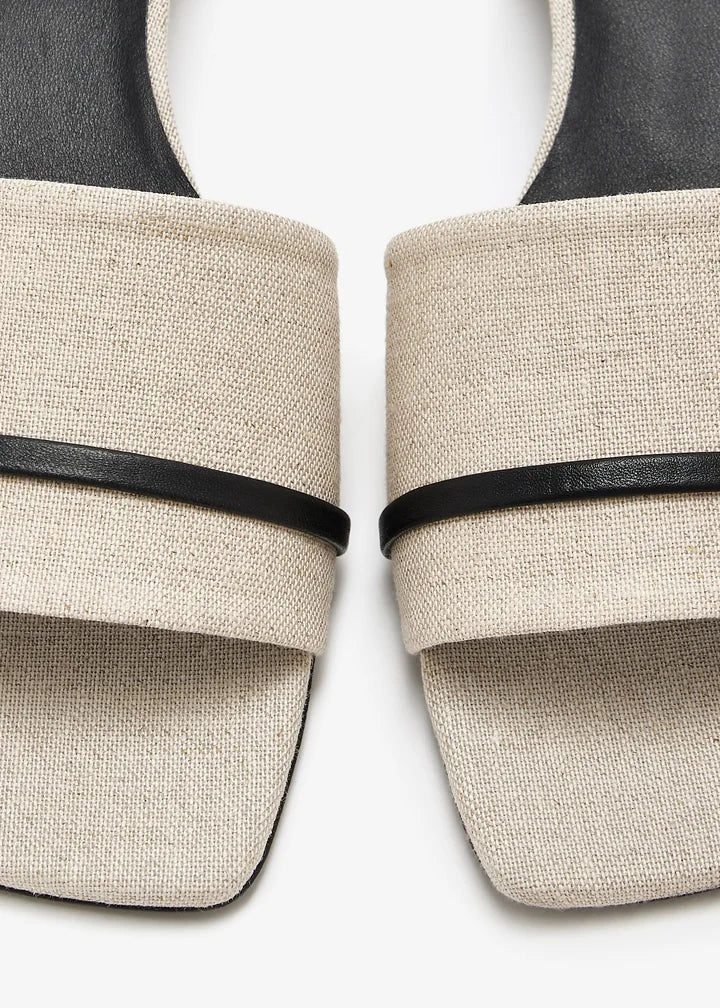 Natural linen slide sandals with black leather strap detail and square toe — The LLine | Endless UAE