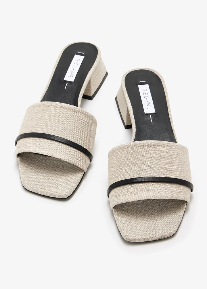 Beige linen square toe mules with black trim and block heels on white background — The LLine | Endless UAE