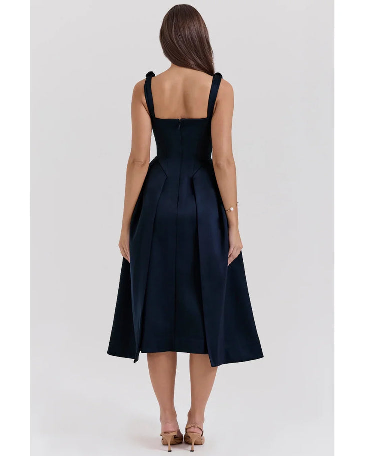 Woman wearing navy blue satin midi dress with twisted shoulder straps and full skirt — House of CB | Endless UAE