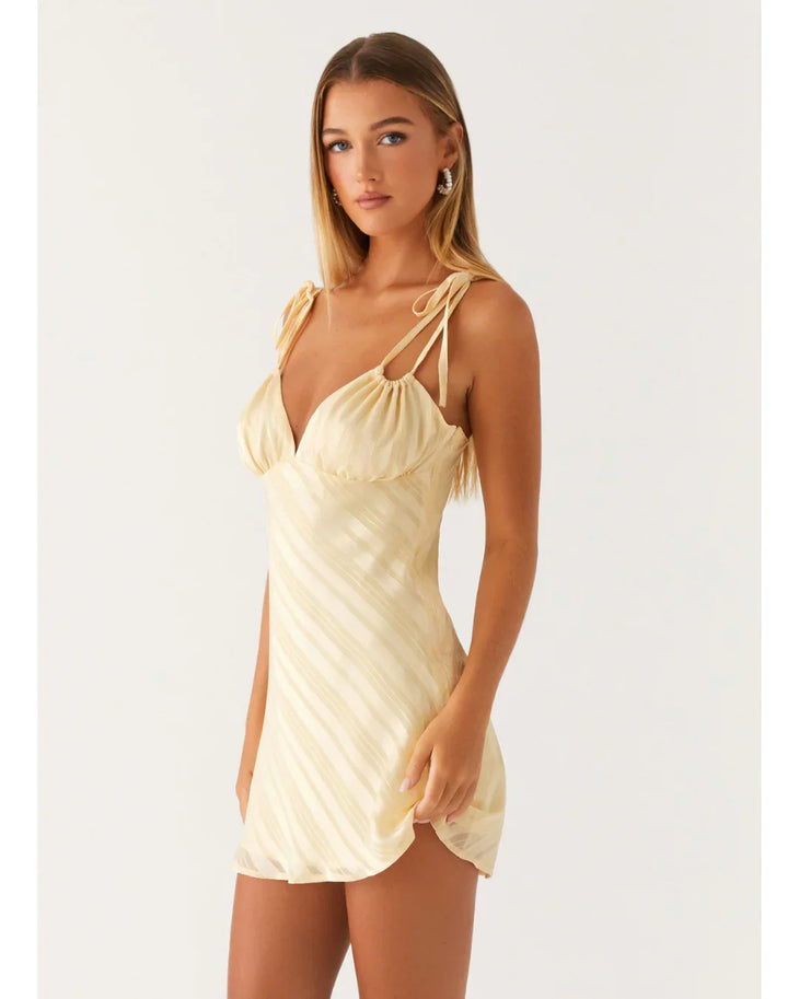 Cream tie-shoulder mini dress with wrap front and diagonal pleats — Peppermayo | Endless UAE