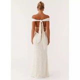 Woman wearing white off-shoulder maxi dress with open back and tie detail, rear view — Peppermayo | Endless UAE